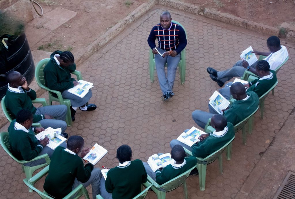 A teacher at St. Aloysius Gonzaga, Kenya takes the students through the AHAPPY Generation manual that is targeted at providing the young people with spiritual guidance and knowledge on HIV Prevention